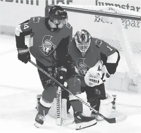  ?? FRED CHARTRAND/THE CANADIAN PRESS ?? Senators goaltender Mike Condon makes a save against the New York Islanders as Mark Borowiecki defends.