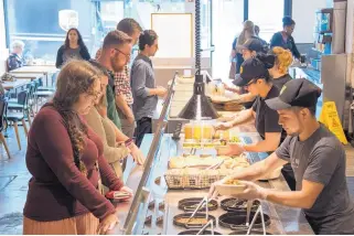  ?? DIXIE D. VEREEN/FOR THE WASHINGTON POST ?? Customers line up and select options at Cava, a chain of fast casual Mediterran­ean restaurant­s.