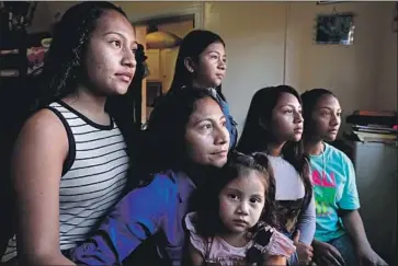  ?? Gary Coronado Los Angeles Times ?? RUBILIA SANCHEZ, second from left, sits with her five daughters at their home in Los Angeles. Sanchez and the four oldest, who were born in Guatemala, fled after being threatened by gang members five years ago.