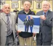  ?? ADAM MACINNIS/THE NEWS ?? Philip MacKenzie, left and Clyde Macdonald, right, presented Barry Trenholm a plaque board photo of Lawrence Hafey and Babe Mason, two of Pictou County’s famed boxers.