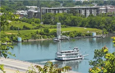  ?? STAFF FILE PHOTO BY TIM BARBER ?? The Southern Belle riverboat moves upstream on the Tennessee River in this view of the land behind the former location of the Casey barge. Now that the barge has been moved, the area is more visible from across the river.