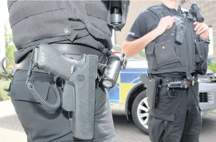  ??  ?? PREPARED Armed police accompanie­d officers as they did the rounds of the Daniel and Lyons crime clans