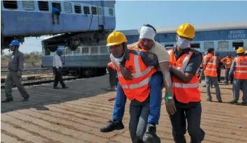  ?? — PTI ?? National Disaster Response Force ( NDRF) and railway employees conduct a joint mock drill for rescue near Sukhi Sewania station at Bhopal on Friday.