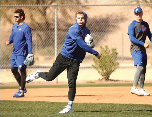  ?? JOHN ANTONOFF/SUN-TIMES ?? Nico Hoerner (above, center) has two seasons of arbitratio­n left, while Ian Happ (left photo) is in his last year of club control. Cubs exec Jed Hoyer is willing to keep working on extensions for both.