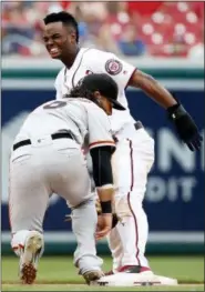  ?? ALEX BRANDON — THE ASSOCIATED PRESS ?? Washington Nationals’ Michael Taylor, top, reacts after San Francisco Giants shortstop Brandon Crawford tags him out after he slid past second base on the steal attempt, during the seventh inning of a baseball game at Nationals Park, Sunday in...