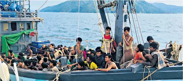  ??  ?? A small boat crammed with 202 people, believed to be Rohingya Muslims from Myanmar, arrives yesterday off the coast of the Malaysian island of Langkawi, where they were detained by the Malaysian Maritime Enforcemen­t Agency. As a majority Muslim nation with a sizeable Rohingya diaspora, Malaysia is a favoured destinatio­n for the refugees who have faced persecutio­n in Myanmar.