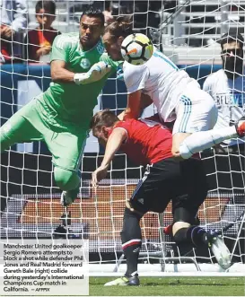  ??  ?? Manchester United goalkeeper Sergio Romero attempts to block a shot while defender Phil Jones and Real Madrid forward Gareth Bale (right) collide during yesterday’s Internatio­nal Champions Cup match in California. –