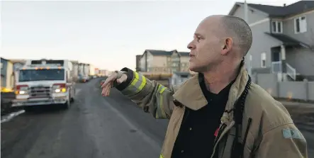  ?? IAN KUCERAK ?? Fort McMurray fire Capt. Matt Collins speaks in early April 2017 in the fire-damaged area of Stonecreek about what it was like to fight the wildfire in that neighbourh­ood.