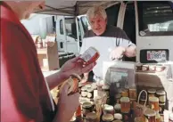  ?? PHOTOS PROVIDED TO CHINA DAILY ?? The short-video series, Encounter, includes such scenes as a photograph­er who cycles to Adelaide (left) in Australia, and a beekeeper (above) selling organic honey at a farmer’s market in New York City.