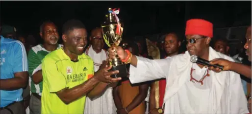  ??  ?? R-L: Oba Ewuare II, handing over the cup to captain of the All Stars FC and deputy governor of Edo state, Comrade Philip Shaibu, winner of the novelty match organised to mark the monarch’s one year anniversar­y on the throne