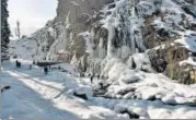  ?? ANI ?? People enjoy near a frozen waterfall at the Drang area in Srinagar on Sunday