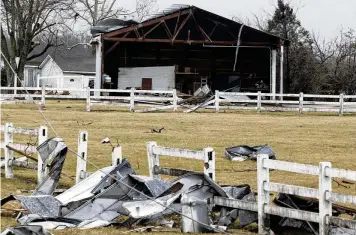  ?? BILL LACKEY PHOTOS / STAFF ?? This barn along Ohio 41 was damaged Wednesday. Two of the townships where Wednesday’s storms did the most damage, Harmony and Springfiel­d townships, do not have warning sirens.