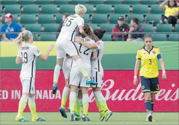  ?? — THE CANADIAN PRESS ?? Members of the United States team celebrate one of their two goals while Colombia’s Natalia Gaitan walks past dejectedly during the second half of their Women’s World Cup round of 16 game at Commonweal­th Stadium in Edmonton Monday night.