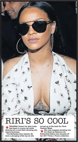  ??  ?? RIHANNA tosses her dark locks tied back in a pony tail while dishing out a cool stare showing she means business.
The Barbados-born beauty, 28, wore a plunging white top as she turned up at the bash for Paris Fashion Week. She was snapped strolling...