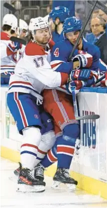  ?? GETTY ?? Montreal’s Josh Anderson checks Braden Schneider into boards in second period of Rangers’ victory at MSG.