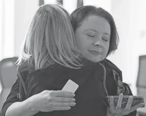  ?? CHRISTINE TANNOUS/THE COMMERCIAL APPEAL ?? Ukrainian immigrant Olena Petrova hugs Shelby County resident Kalyna Hanover following a public awareness event to discuss the conflict in Ukraine held by Shelby County Mayor Lee Harris on March 1 at the Vasco A. Smith Jr. County Administra­tion Building in Memphis.