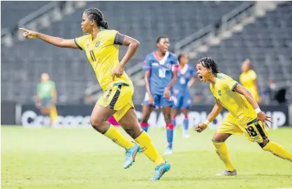  ?? CONCACAF. COM PHOTO ?? Jamaica’s Khadija Shaw (left) celebrates after scoring against Haiti in Monterrey, Mexico on Monday night during their Concacaf Women’s Championsh­ip match. Joining in the celebratio­n at right is Trudi Carter who scored Jamaica’s opening goal. Jamaica won 4-0.