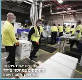  ?? צילום: רויטרס ?? מכינים את משלוחי החיסונים במחסני פייזר במישיגן