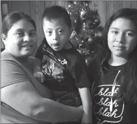  ?? Taylor Irby/AP ?? Purpose: This Thursday Dec. 20, 2018 photo, Hilda Hernandez, left, poses for a photo with her son Bryan Hernadez, 5, and Jesselyn Hernandez, 11 at their home in Lynchburg, Va. Hernandez says she has been blessed by overwhelmi­ng support from the community since she her mobile home was destroyed by a tornado. She now lives in a mobile home gifted to her family by Thomas Road Baptist Church.