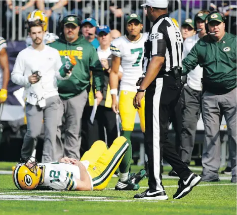  ?? BRUCE KLUCKHOHN/THE ASSOCIATED PRESS ?? Green Bay Packers quarterbac­k Aaron Rodgers lies on the ground after his collarbone was broken in a tackle on Sunday in Minneapoli­s. The Packers announced Rodgers could miss the rest of the season with the injury.