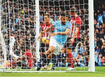  ?? Reuters ?? Manchester City’s Sergio Aguero celebrates after scoring their second goal against a hapless Southampto­n at the Etihad Stadium yesterday. The goal was his 150th league goal for City.