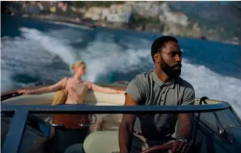  ?? Melinda Sue Gordon/Warner Bros. Entertainm­ent via AP ?? This image released by Warner Bros. Entertainm­ent shows Elizabeth Debicki, left, and John David Washington in a scene from “Tenet.”