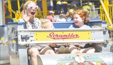  ?? Alex von Kleydorff / Hearst Connecticu­t Media ?? Above, Jenn Falik takes a spin on the scrambler with daughter Goldie and Emme Dorfman while at the Yankee Doodle Fair on Sunday in Westport.