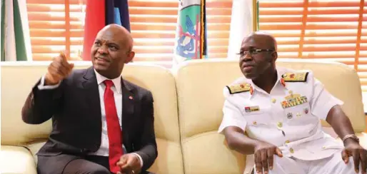  ??  ?? Mr. Tony Elumelu (left) pointing at something of interest to his host, NDC Commandant, Rear Admiral Adeniyi Osinowo, during the former's courtesy visit