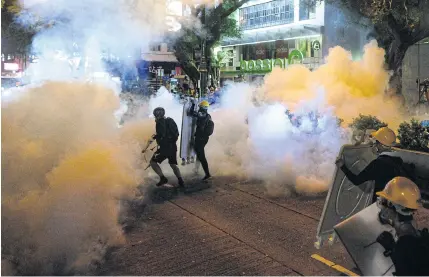  ?? AFP Police fire tear gas during a protest in Tsim Sha Tsui district in Hong Kong on Saturday. ??