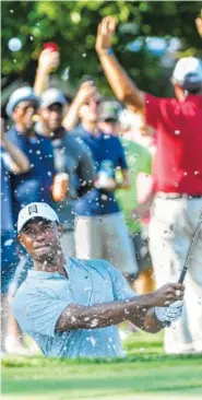  ?? AP PHOTO/JOHN AMIS ?? Tiger Woods hits up to the 13th green during the second round of the Tour Championsh­ip on Friday in Atlanta.