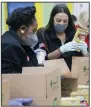  ?? (AP/Houston Chronicle/ Elizabeth Conley) ?? U.S. Rep. Sheila Jackson Lee, D-Texas, (left) and U.S. Rep. Alexandria Ocasio-Cortez, D-N.Y., join other volunteers Saturday at the Houston Food Bank. Ocasio-Cortez said she helped raise more than $3 million for Texas storm relief.