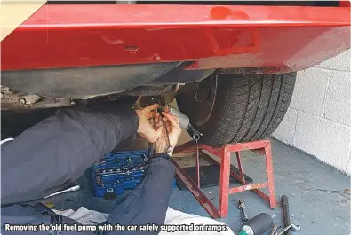  ??  ?? Removing the old fuel pump with the car safely supported on ramps.