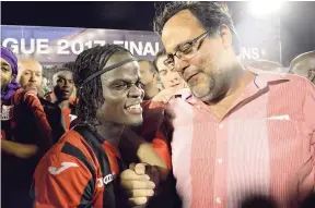  ?? FILE ?? In this file photo from June 5, 2017, Mark Golding (right) is pictured celebratin­g Arnett Gardens’ winning the Red Stripe Premier League title with midfielder Marvin Morgan (centre) and his teammates. Golding was officially appointed the club’s new...