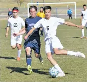  ?? ANDREW MARTINEZ/THE NEW MEXICAN ?? Robertson’s Justin Gold-Lujan, right, clears a ball in front of Santa Fe Prep’s Harrison Miller on Saturday in Las Vegas, N.M. The Cardinals beat the Blue Griffins, 1-0, and won the District 2-1A/4A championsh­ip.