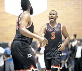  ?? Patrick T. Fallon For The Times ?? CHRIS PAUL, right, has a word with LAUNFD teammate James Harden during Sunday’s Drew League game. The Rockets players helped lead the team to victory.