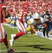  ?? CHARLIE RIEDEL/ASSOCIATED PRESS ?? The Chargers’ Austin Ekeler dives for a TD past the Chiefs’ Tyrann Mathieu during the second quarter Sunday as San Diego took a 14-3 lead.