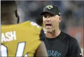  ?? MARK ZALESKI — THE ASSOCIATED PRESS FILE ?? Then Jacksonvil­le Jaguars head coach Gus Bradley talks to defensive tackle Richard Ash, left, in the second half of a game against the Tennessee Titans in October of 2016.