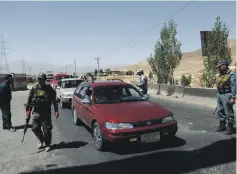  ?? Reuters ?? Afghan security forces keep watch yesterday at a checkpoint on the Ghazni motorway in Maidan Shar, Afghanista­n