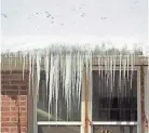  ?? KELLY WILKINSON/THE STAR ?? Ice dams above gutters, formed as snow melts and freezes, can damage shingles and create roof leaks, experts say.