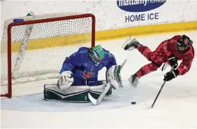  ?? STEVE RUSSELL TORONTO STAR ?? Team Canada’s Jade Downie-Landry tries to get the puck past Team USA goalkeeper Abbie Ives in the Premier Hockey Federation all-star game on Sunday night in Toronto.