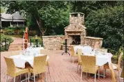  ?? CONTRIBUTE­D PHOTOS BY ANDREW THOMAS LEE ?? In historic Roswell, Table & Main offers a brick-paved garden patio surrounded by lush greenery, with a stone fireplace to warm up diners in cooler weather.