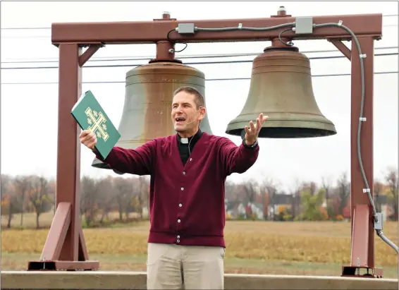  ?? SUBMITTED PHOTOS — LEANN SACKS ?? Rev. Scott Lingenfelt­er during the Hope Church dedication of the bell restoratio­n project. One bell is from St. Paul’s Lutheran in Lyons and the other is from Trinity Lutheran in Bowers. Now both bells ring out front of Hope Church in Bowers.