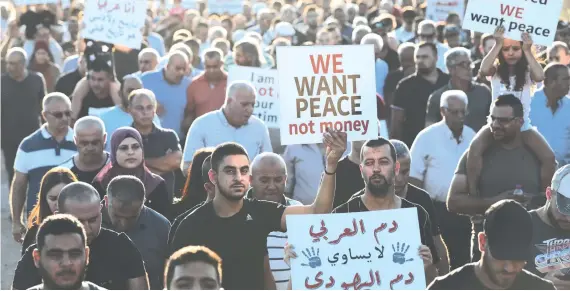  ?? AFP ?? Israeli Arabs, who suffer from widespread discrimina­tion, protest against violence, organized crime and recent killings among their communitie­s, in the Arab town of Majd Al-Krum.