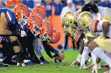  ?? MIKE EHRMANN/GETTY ?? If we want to see the Florida Gators line up against the Florida State Seminoles for years to come, college athletics programs must finally make smart financial decisions and cut bloated budgets amid the coronaviru­s pandemic.