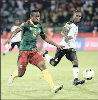  ??  ?? Christian Bassogog of Cameroon, left, scores their second goal against Ghana in Francevill­e.