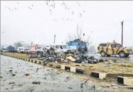  ?? REUTERS ?? ■ Soldiers examine the debris after a terrorist attacked a CRPF convoy in Pulwama on Thursday.