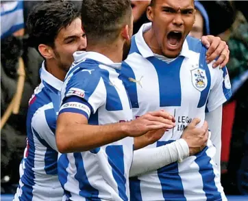  ??  ?? Controvers­y: Quaner roars after his very late winner for Huddersfie­ld