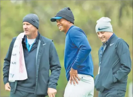  ?? AFP ?? Tiger Woods (C) and caddie Joe Lacava during a practice round prior to the PGA Championsh­ip at Bethpage Black on Monday.