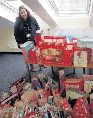  ??  ?? Presents received from Hafod y Wennol with Karen Evans, Bridgend County Borough Council.