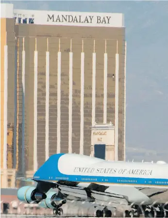  ?? ROBYN BECK / AGENCE FRANCE-PRESSE / GETTY IMAGES ?? Air Force One lands in Las Vegas Wednesday, within view of the Mandalay Bay resort.